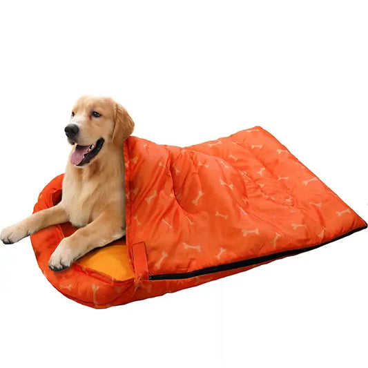 Happy golden retriever enjoying a cozy orange waterproof dog sleeping bag, perfect for outdoor adventures.