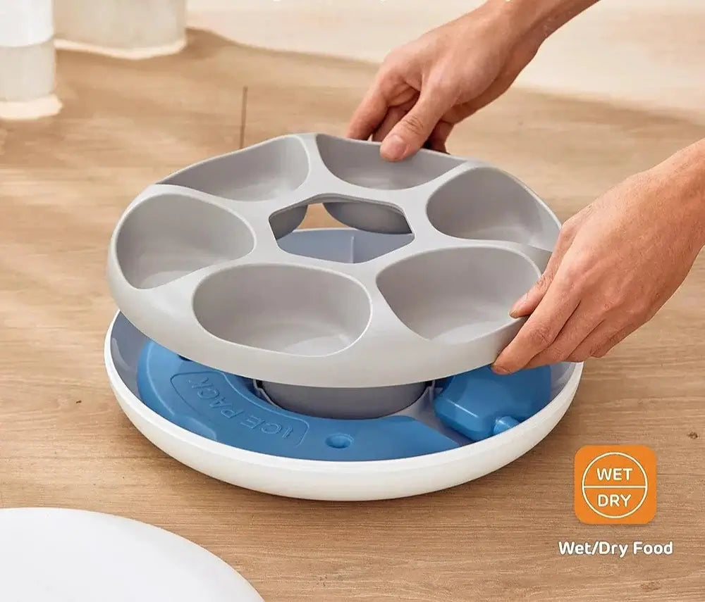 User assembling WiFi Smart Pet Feeder with portion control for wet and dry food options on a wooden surface.