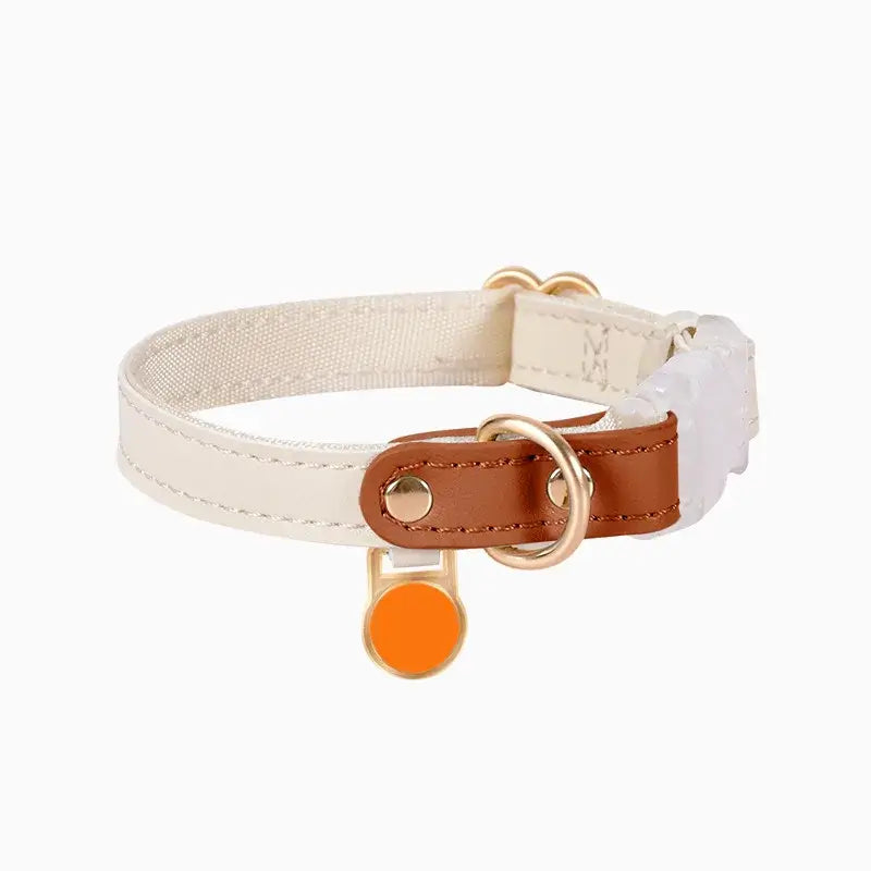 Anti-lost cat leather harness with adjustable nameplate and orange tag, designed for comfort and safety.
