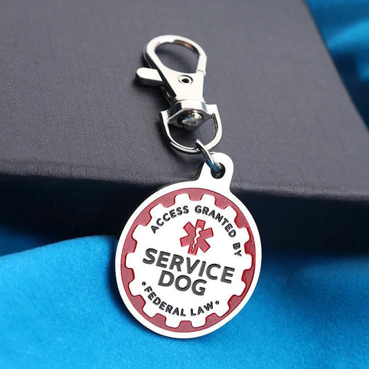 Red and white service dog tag with clip, displaying "Access Granted by Federal Law" on blue fabric background.