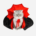 Load image into Gallery viewer, Grey cat wearing a red and black vampire cloak pet costume with a whimsical cape design.
