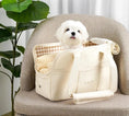 Load image into Gallery viewer, White dog in Comfort Pet Carrier Bag on a chair with green plant in the background - littlepawgive
