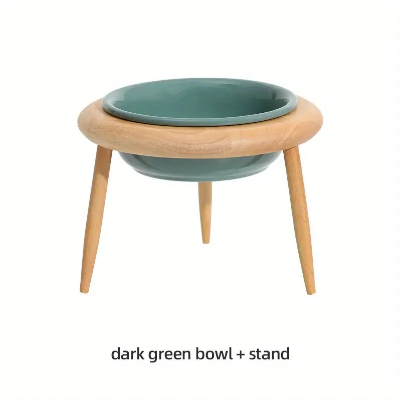 Adjustable dark green ceramic pet bowl on wooden stand for dogs and cats, promoting healthy eating posture.